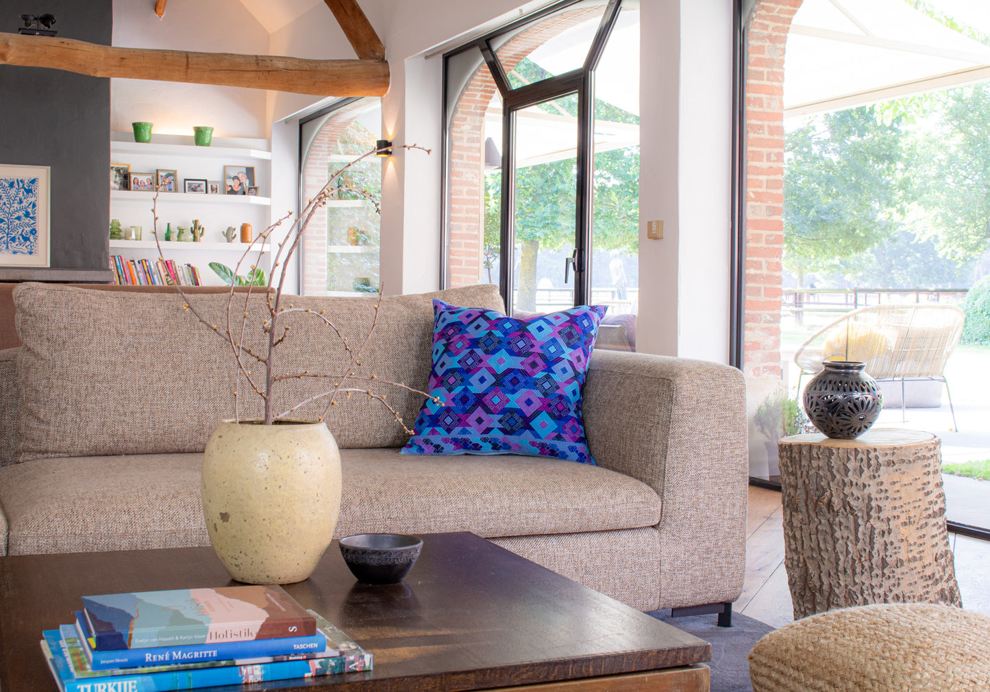 Light blue Chiapas cushion with intricate diamond shapes in vibrant colors, elevating living room decor.