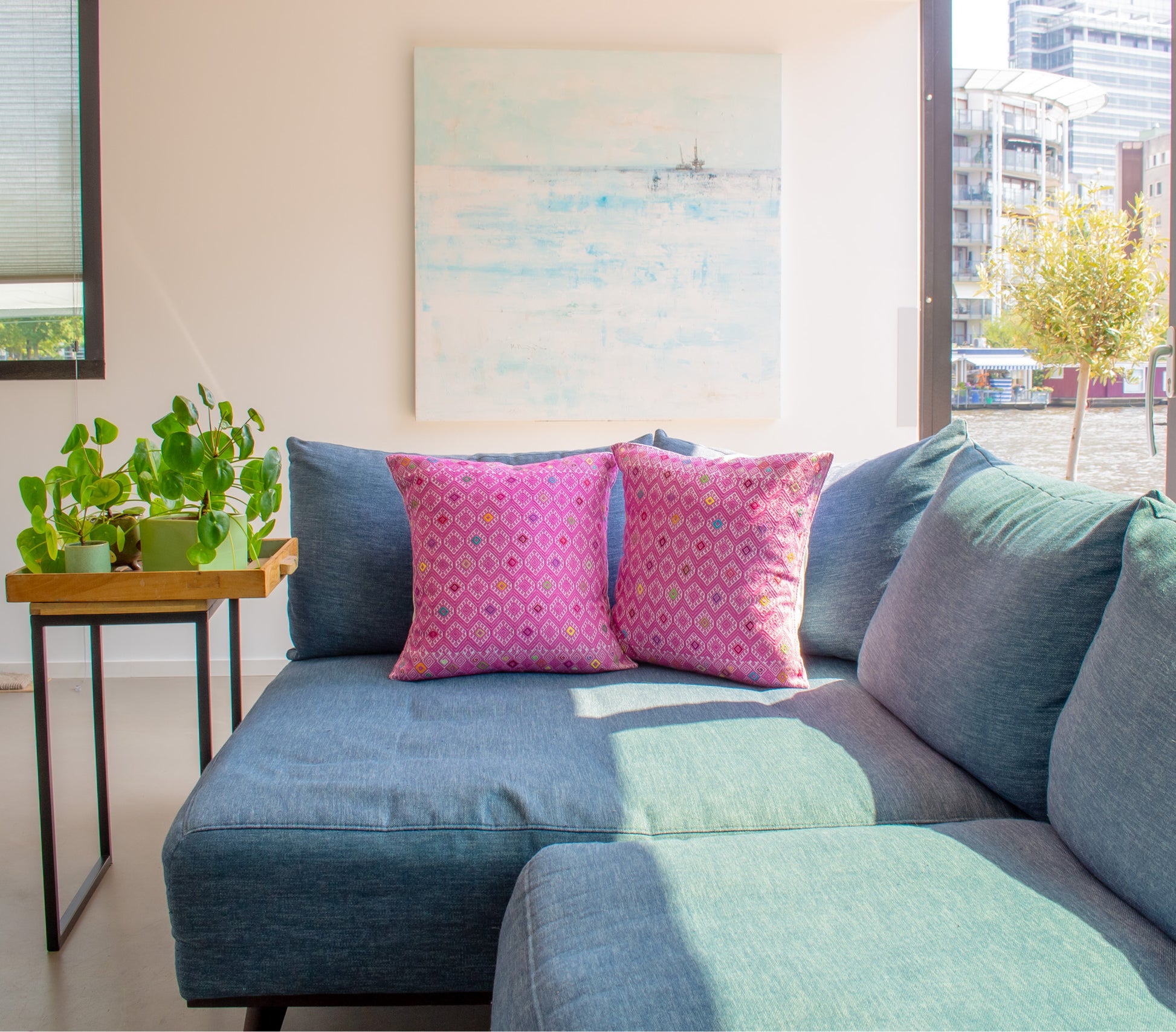 Vibrant pink cushion with diamond brocade pattern, elevating living room decor.