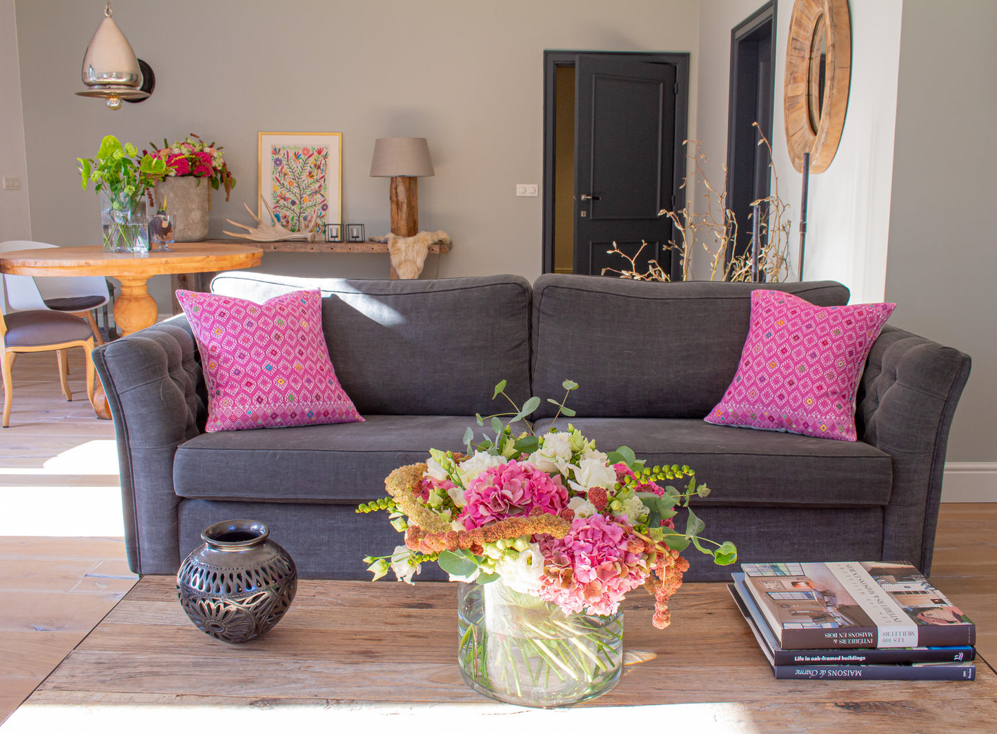 Vibrant pink cushion with diamond brocade pattern, elevating living room decor.