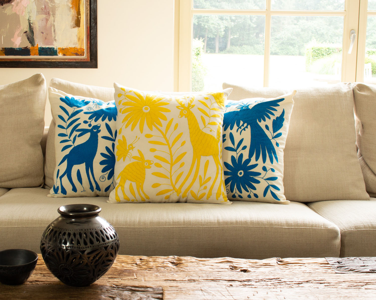 Handcrafted Tenango Otomi Embroidery Cushion with Animal and Flower Designs, elevating living room decor.