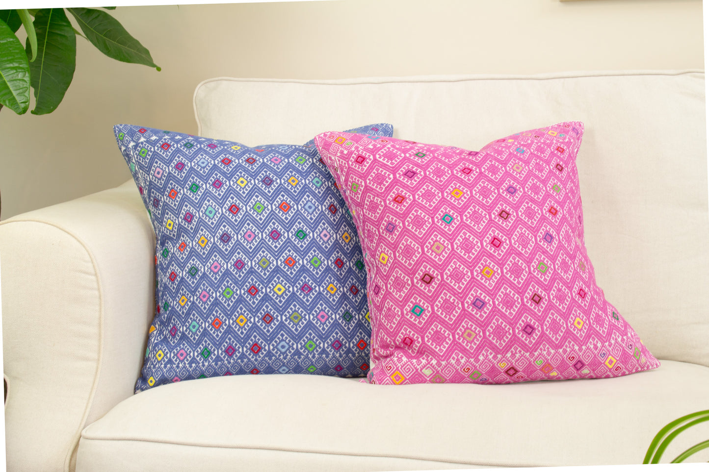 Vibrant blue and pink cushion, diamond brocade pattern with vibrant hues, elevating living room decor.