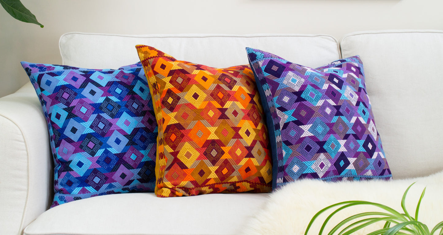 Juanas Chiapas Cushions Collection with intricate diamond shapes in vibrant colors, elevating living room decor.