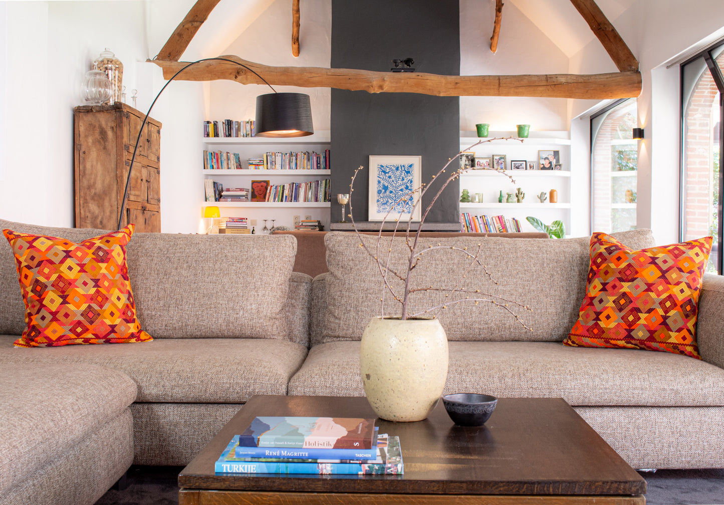 Orange Chiapas cushion with intricate diamond shapes in vibrant colors, elevating living room decor.