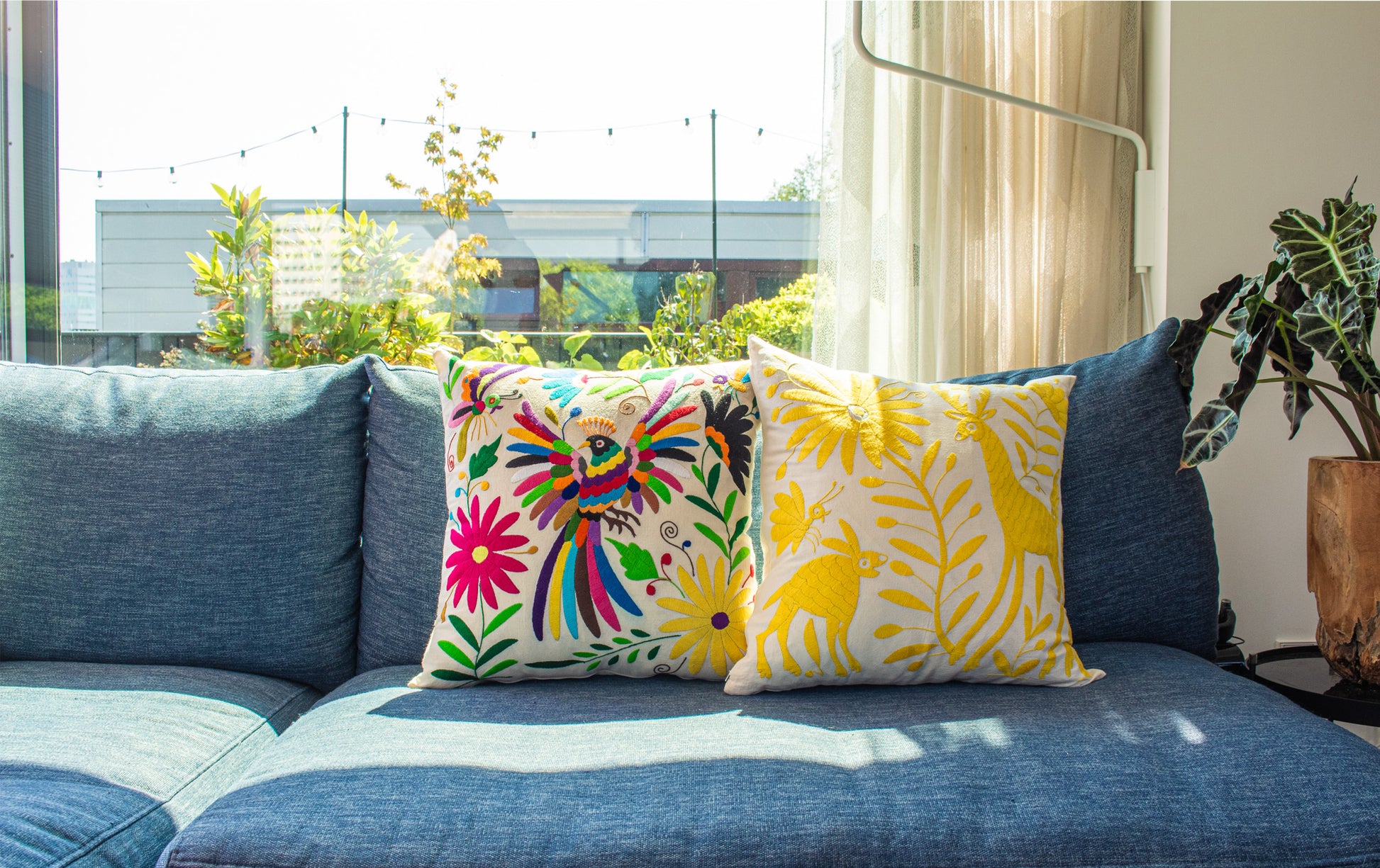 Handcrafted Tenango Otomi Embroidery Cushion with Animal and Flower Designs, elevating living room decor.