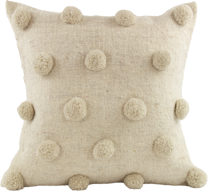 Beige Cushion crafted from 100% wool, adorned with charming beige pom poms and featuring a secure folding back with cute delicate ribbons closure.